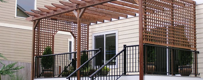 Ipe Pergola with Ipe lattice over a Trex deck with black aluminum picket railing. located in Bellingham, WA