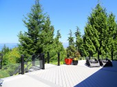 Frameless glass railing with lit post caps on a Timbertech PVC deck in Anacortes