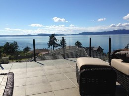 Waterproof paver deck with topless glass infinity railing in Anacortes