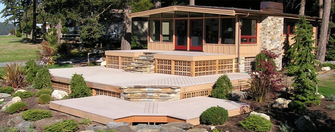 Beautiful photo of a muli level composite deck with natural stone steps and cedar lattice